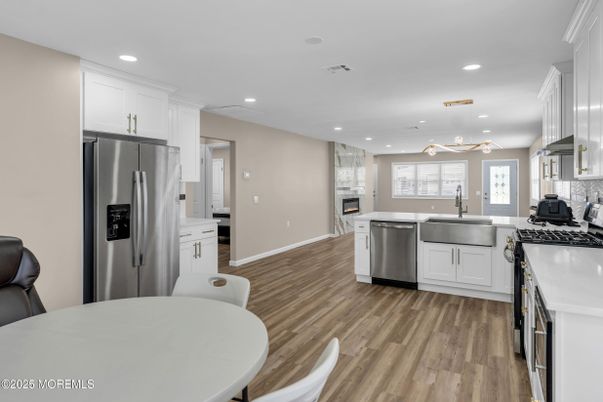 Dining room, Fireplace, Interior, Kitchen, Pendant Lights, Recessed Lighting, Stainless Steel Appliances, Wood Texture Flooring