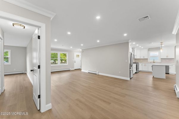 Empty room, Interior, Kitchen, Pendant Lights, Recessed Lighting, Stainless Steel Appliances, Wood Texture Flooring