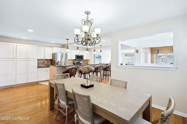 Chandelier, Dining room, Interior, Kitchen, Recessed Lighting, Stainless Steel Appliances, Wood Texture Flooring