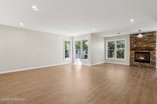 Empty room, Fireplace, Interior, Recessed Lighting, Stone Walls, Wood Texture Flooring