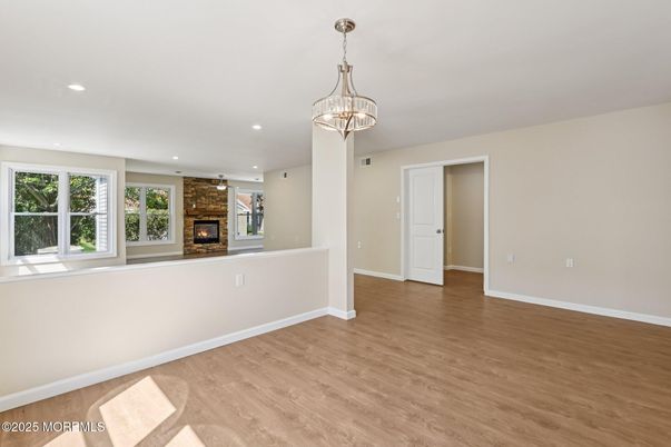 Chandelier, Empty room, Fireplace, Interior, Recessed Lighting, Wood Texture Flooring