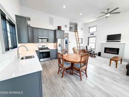 Dining room, Fireplace, Interior, Kitchen, Recessed Lighting, Stainless Steel Appliances, Wood Texture Flooring