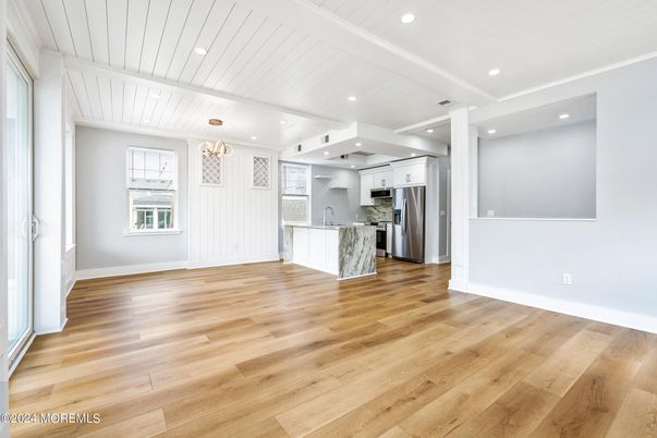 Empty room, Interior, Kitchen, Pendant Lights, Recessed Lighting, Stainless Steel Appliances, Wood Texture Flooring