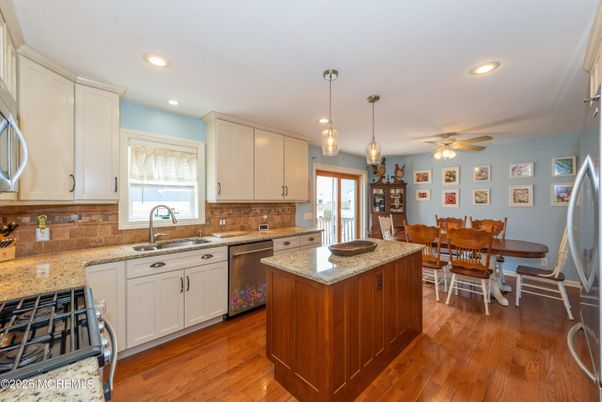 Dining room, Interior, Kitchen, Pendant Lights, Recessed Lighting, Stainless Steel Appliances, Wood Texture Flooring