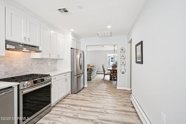 Dining room, Interior, Kitchen, Pendant Lights, Recessed Lighting, Stainless Steel Appliances, Wood Texture Flooring