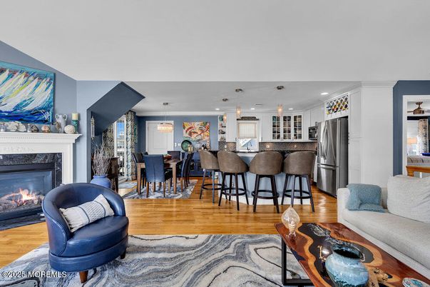 Dining room, Fireplace, Interior, Kitchen, Living room, Pendant Lights, Recessed Lighting, Stainless Steel Appliances, Wood Texture Flooring