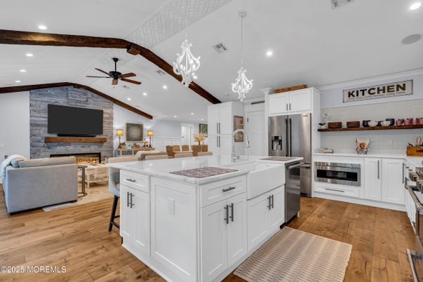 Fireplace, Interior, Kitchen, Living room, Pendant Lights, Recessed Lighting, Stainless Steel Appliances, Stone Walls, Wood Texture Flooring