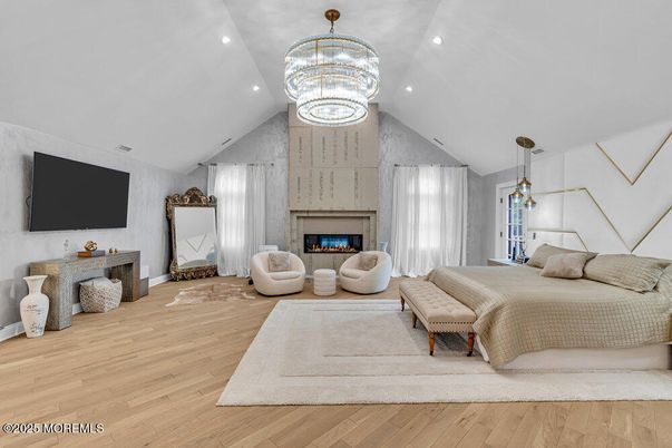 Bedroom, Chandelier, Fireplace, Interior, Recessed Lighting, Wood Texture Flooring