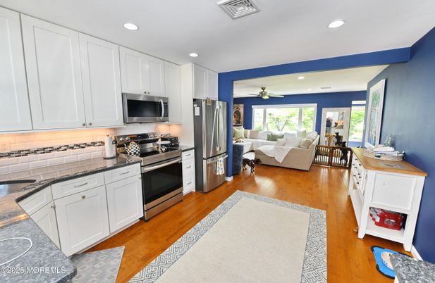 Dining room, Interior, Kitchen, Living room, Recessed Lighting, Stainless Steel Appliances, Wood Texture Flooring