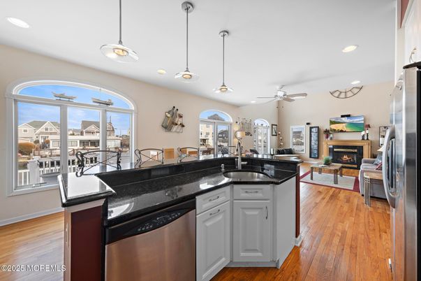 Dining room, Fireplace, Interior, Kitchen, Living room, Pendant Lights, Recessed Lighting, Stainless Steel Appliances, Wood Texture Flooring