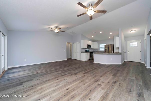 Empty room, Interior, Kitchen, Recessed Lighting, Stainless Steel Appliances, Wood Texture Flooring
