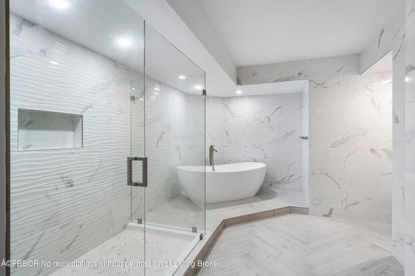 Bathroom, Free Standing Baths, Glass Shower, Interior, Marble Walls, Recessed Lighting, Wood Texture Flooring