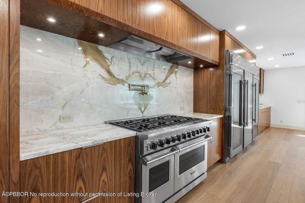 Interior, Kitchen, Marble Walls, Recessed Lighting, Stainless Steel Appliances, Wood Texture Flooring