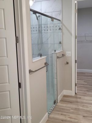 Bathroom, Glass Shower, Interior, Marble Walls, Wood Texture Flooring