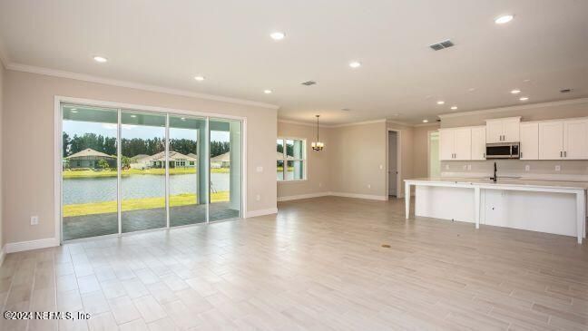 Chandelier, Empty room, Interior, Kitchen, Pendant Lights, Recessed Lighting, Stainless Steel Appliances, Water, Wood Texture Flooring