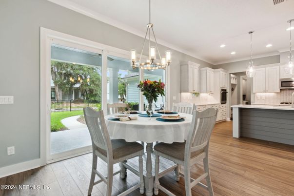 Chandelier, Dining room, Interior, Kitchen, Pendant Lights, Recessed Lighting, Stainless Steel Appliances, Wood Texture Flooring