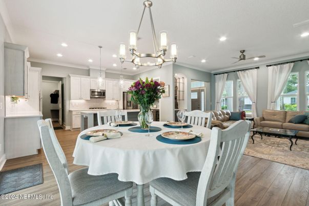 Chandelier, Dining room, Interior, Kitchen, Living room, Pendant Lights, Recessed Lighting, Stainless Steel Appliances, Wood Texture Flooring