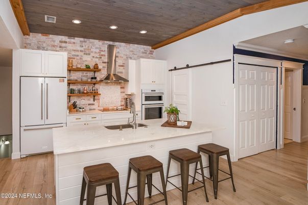 Interior, Kitchen, Recessed Lighting, Stainless Steel Appliances, Stone Walls, Wood Texture Flooring