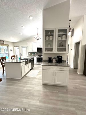 Chandelier, Dining room, Interior, Kitchen, Pendant Lights, Recessed Lighting, Stainless Steel Appliances, Wood Texture Flooring