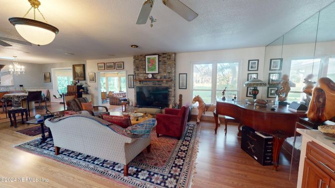 Chandelier, Dining room, Fireplace, Interior, Living room, Piano, Stone Walls, Wood Texture Flooring