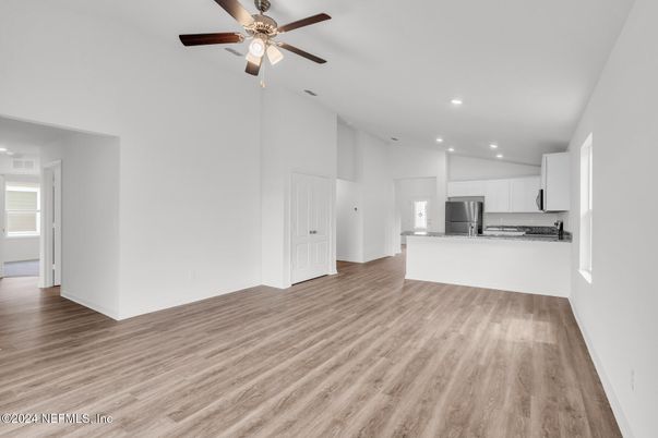 Empty room, Interior, Kitchen, Recessed Lighting, Stainless Steel Appliances, Wood Texture Flooring
