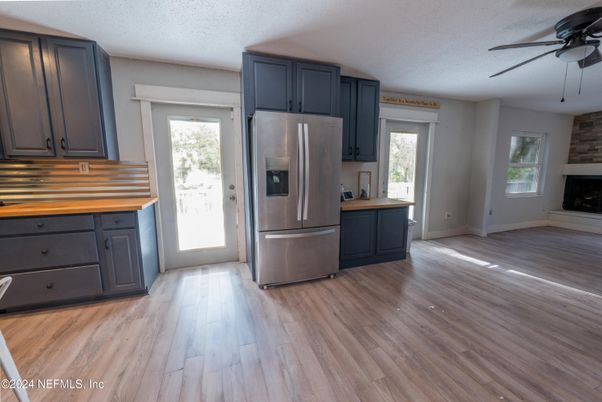 Fireplace, Interior, Kitchen, Stainless Steel Appliances, Wood Texture Flooring