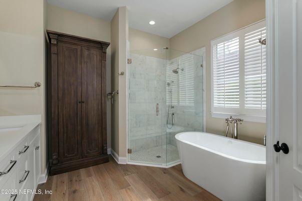 Bathroom, Free Standing Baths, Glass Shower, Interior, Marble Walls, Recessed Lighting, Wood Texture Flooring