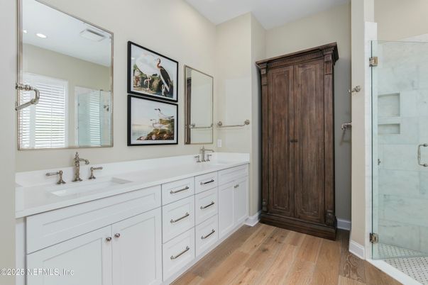 Bathroom, Dual Sink Vanities, Glass Shower, Interior, Marble Walls, Recessed Lighting, Wood Texture Flooring