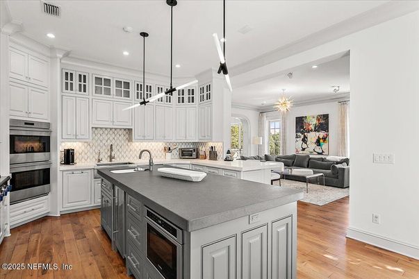 Chandelier, Interior, Kitchen, Living room, Pendant Lights, Recessed Lighting, Stainless Steel Appliances, Wood Texture Flooring