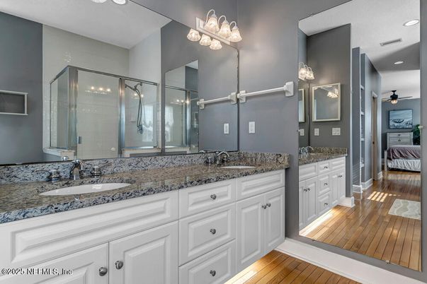 Bathroom, Dual Sink Vanities, Glass Shower, Interior, Recessed Lighting, Wood Texture Flooring