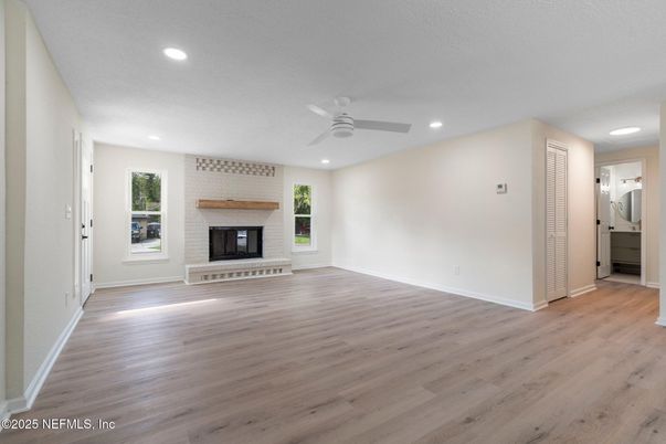 Empty room, Fireplace, Interior, Recessed Lighting, Stone Walls, Wood Texture Flooring