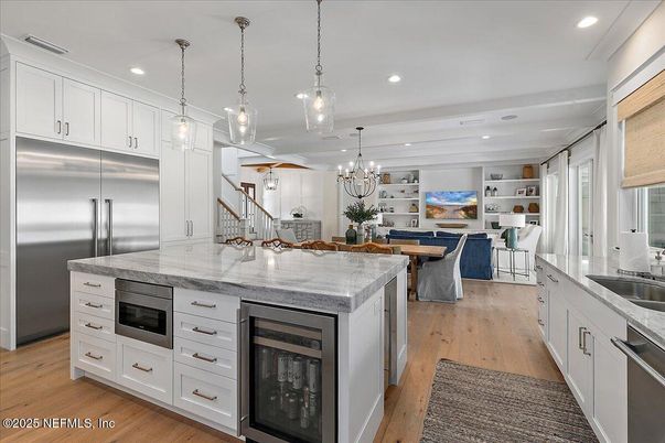Chandelier, Dining room, Interior, Kitchen, Living room, Pendant Lights, Recessed Lighting, Stainless Steel Appliances, Wood Texture Flooring