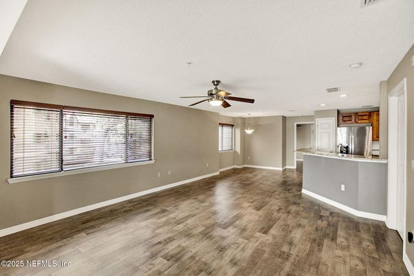Empty room, Interior, Kitchen, Pendant Lights, Recessed Lighting, Stainless Steel Appliances, Wood Texture Flooring
