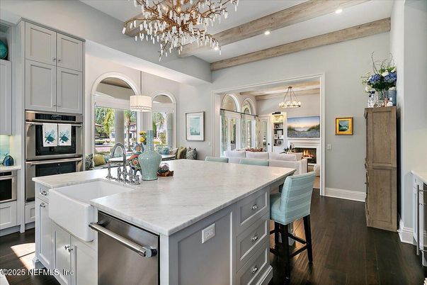 Chandelier, Dining room, Fireplace, Interior, Kitchen, Living room, Pendant Lights, Recessed Lighting, Stainless Steel Appliances, Wood Texture Flooring