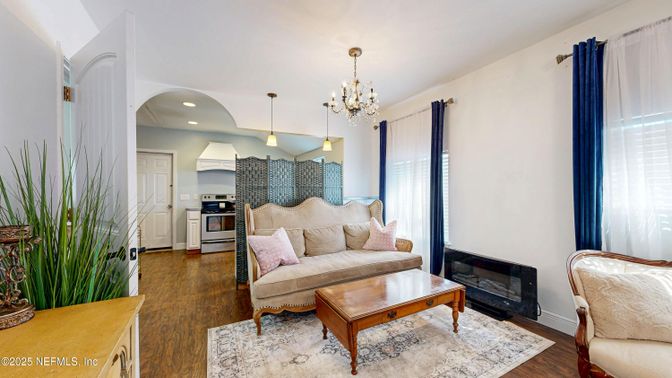 Chandelier, Fireplace, Interior, Kitchen, Living room, Pendant Lights, Recessed Lighting, Stainless Steel Appliances, Wood Texture Flooring