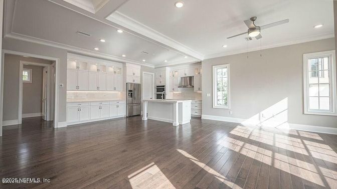 Empty room, Interior, Kitchen, Recessed Lighting, Stainless Steel Appliances, Wood Texture Flooring