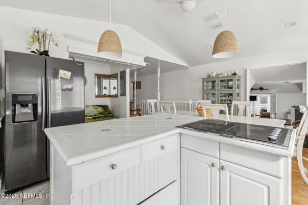 Dining room, Interior, Kitchen, Pendant Lights, Stainless Steel Appliances, Tile Countertops, Wood Texture Flooring