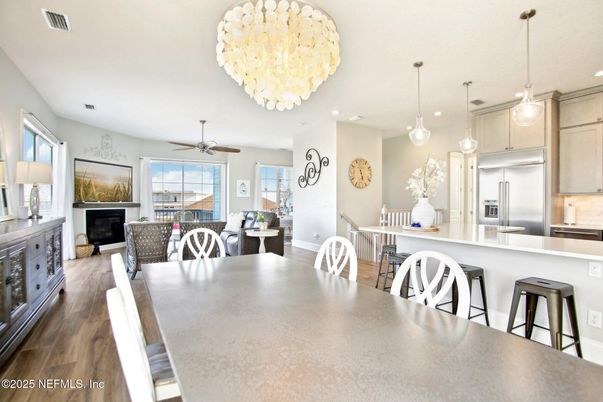Chandelier, Dining room, Fireplace, Interior, Kitchen, Pendant Lights, Recessed Lighting, Stainless Steel Appliances, Wood Texture Flooring