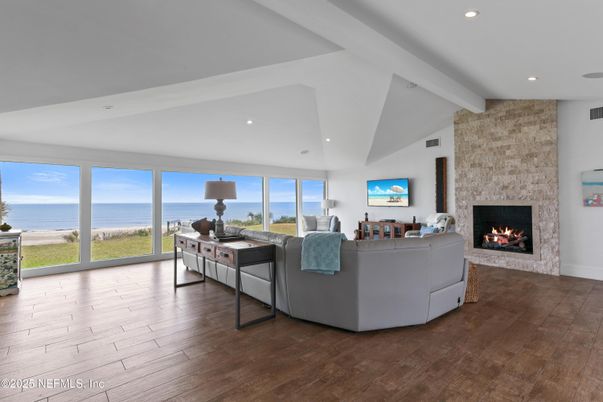 Fireplace, Interior, Living room, Recessed Lighting, Stone Walls, Water, Wood Texture Flooring