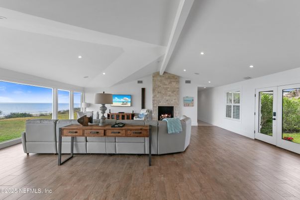 Fireplace, Interior, Living room, Recessed Lighting, Stone Walls, Water, Wood Texture Flooring