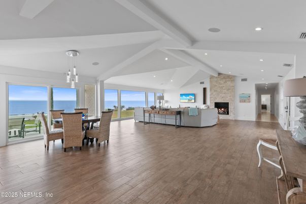 Dining room, Fireplace, Interior, Living room, Pendant Lights, Recessed Lighting, Stone Walls, Water, Wood Texture Flooring
