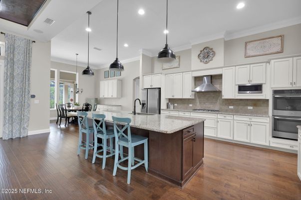 Dining room, Interior, Kitchen, Pendant Lights, Recessed Lighting, Stainless Steel Appliances, Wood Texture Flooring