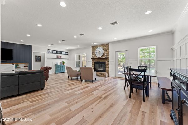 Dining room, Fireplace, Interior, Living room, Recessed Lighting, Stone Walls, Wood Texture Flooring