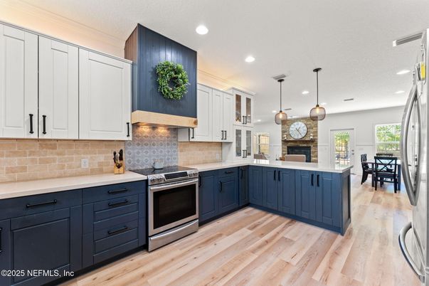 Dining room, Fireplace, Interior, Kitchen, Pendant Lights, Recessed Lighting, Stainless Steel Appliances, Wood Texture Flooring