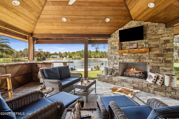 Exterior, Fireplace, Interior, Living room, Recessed Lighting, Stone Walls, Water, Wooden Ceilings