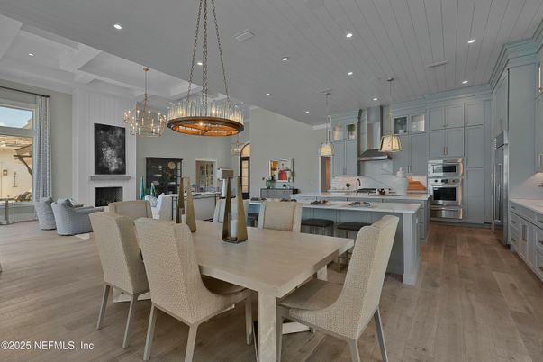 Chandelier, Dining room, Fireplace, Interior, Kitchen, Living room, Pendant Lights, Recessed Lighting, Stainless Steel Appliances, Wood Texture Flooring