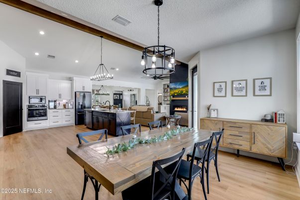 Chandelier, Dining room, Fireplace, Interior, Kitchen, Living room, Pendant Lights, Recessed Lighting, Stainless Steel Appliances, Wood Texture Flooring