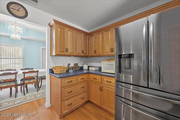 Chandelier, Dining room, Interior, Kitchen, Stainless Steel Appliances, Wood Texture Flooring