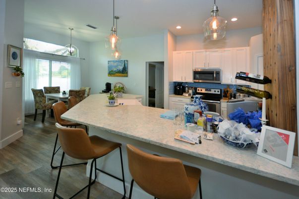 Dining room, Interior, Kitchen, Pendant Lights, Recessed Lighting, Stainless Steel Appliances, Wood Texture Flooring