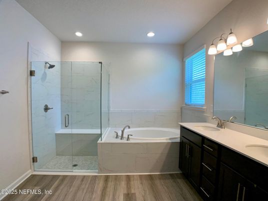 Bathroom, Dual Sink Vanities, Glass Shower, Interior, Marble Walls, Recessed Lighting, Wood Texture Flooring